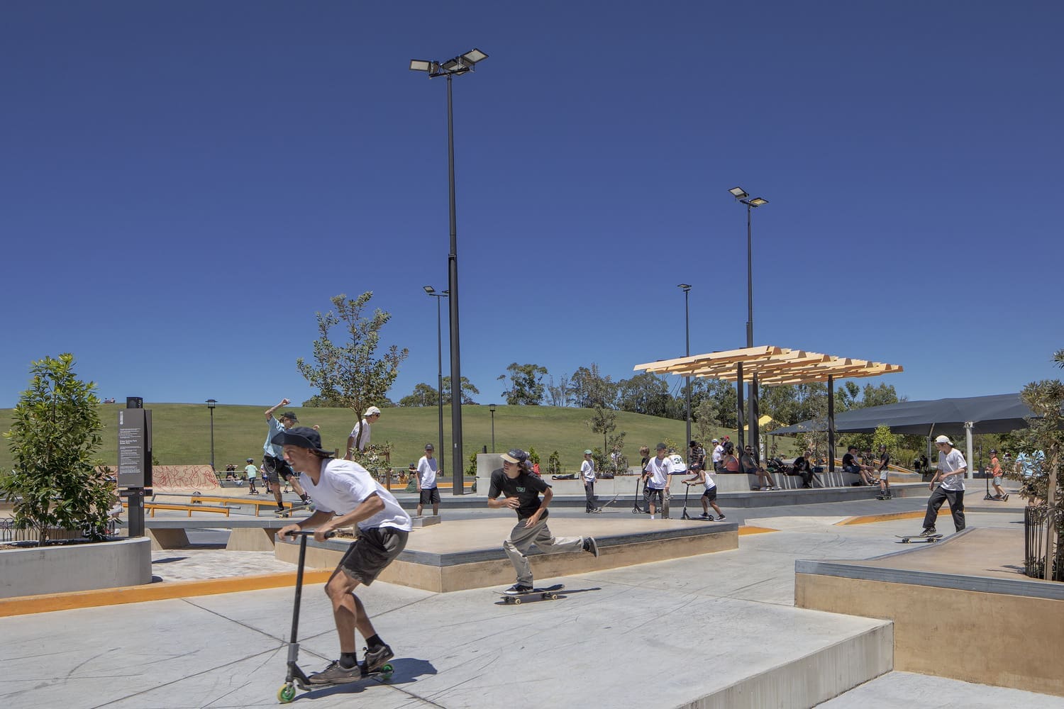 people using skateboards and scooters at the Sydney Skate Park